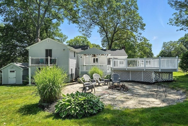 15 Oak Bluff Cir, East Longmeadow, MA 01028 - rear view of house featuring a patio, a wooden deck, a yard, a shed, and a chimney