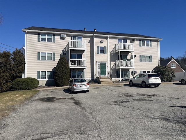 view of building exterior with uncovered parking