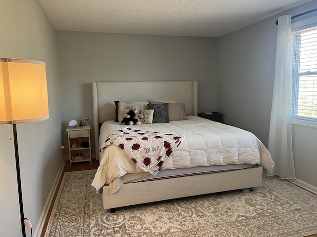 bedroom featuring multiple windows and baseboards