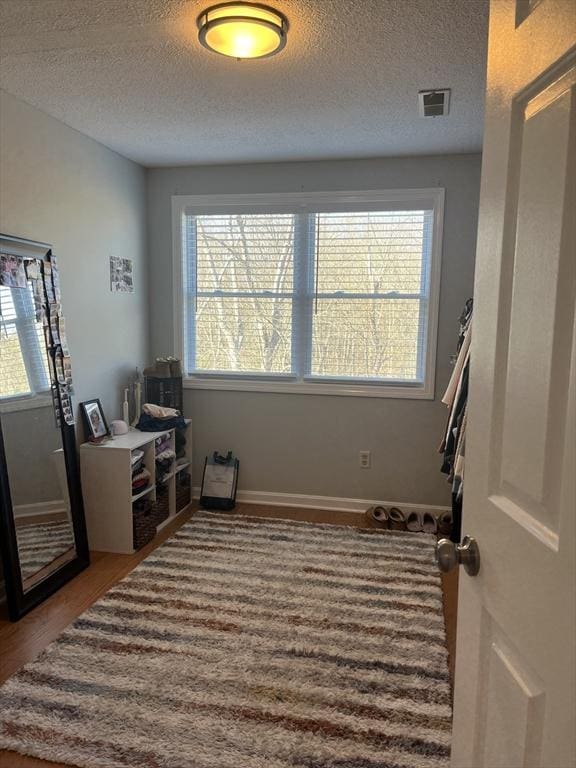 office area featuring plenty of natural light, a textured ceiling, and baseboards
