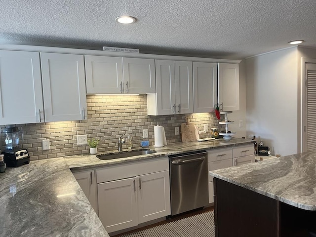 kitchen featuring dishwasher, a sink, a textured ceiling, decorative backsplash, and white cabinetry