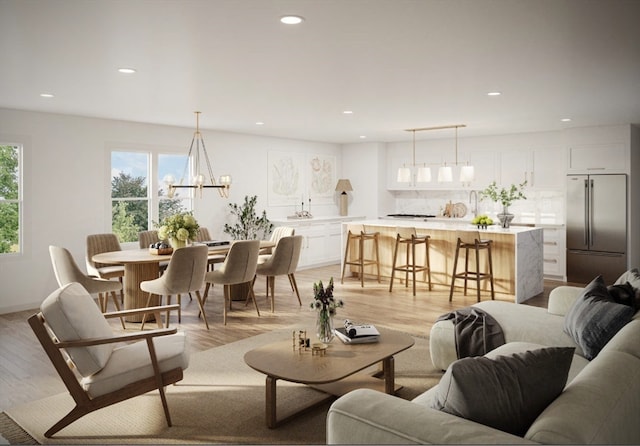 living room with a chandelier and light hardwood / wood-style floors