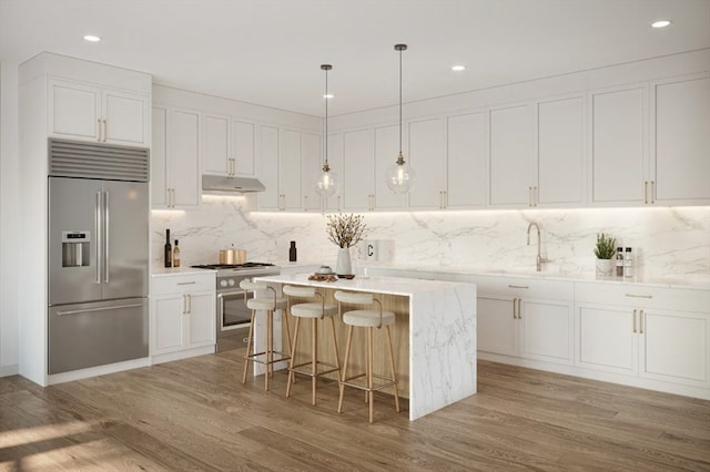 kitchen featuring high end appliances and white cabinetry