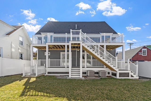 rear view of house featuring central AC unit, a yard, and a deck