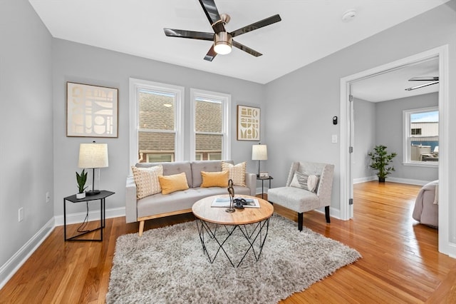 living room featuring ceiling fan and light wood-type flooring