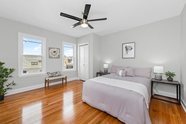 bedroom with a closet, ceiling fan, and light wood-type flooring