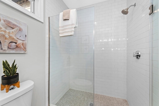 bathroom with an enclosed shower and toilet