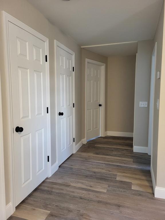 corridor with dark wood-type flooring