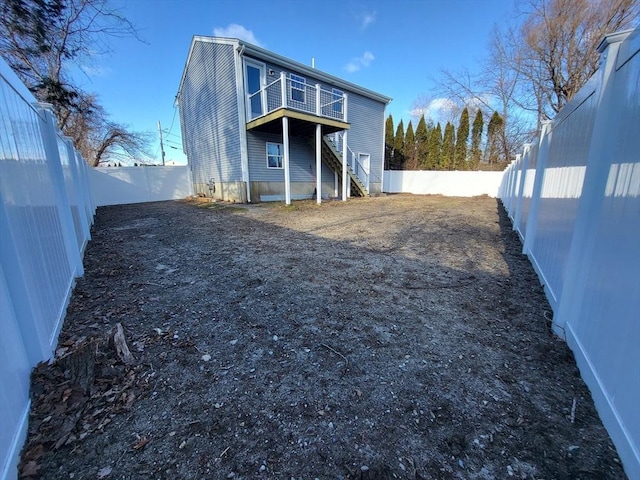 rear view of property with a balcony