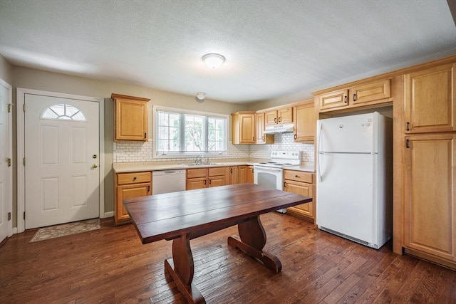 kitchen with white appliances, backsplash, dark wood finished floors, and light brown cabinets