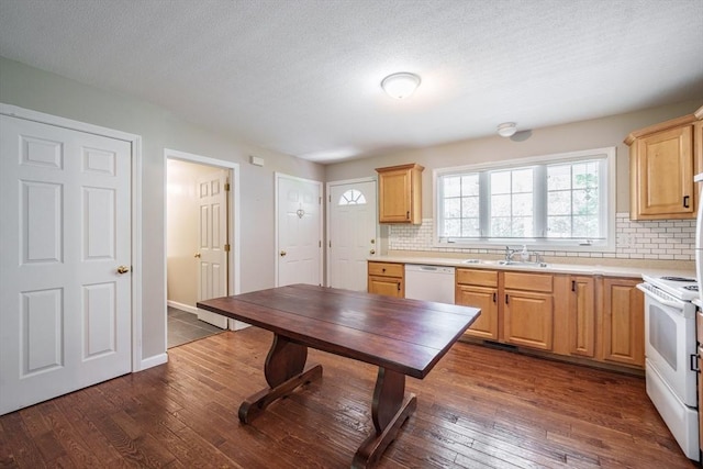 kitchen with white appliances, a sink, backsplash, dark wood-style flooring, and a textured ceiling