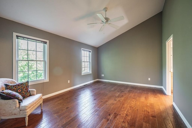 unfurnished room with hardwood / wood-style floors, ceiling fan, baseboards, and high vaulted ceiling