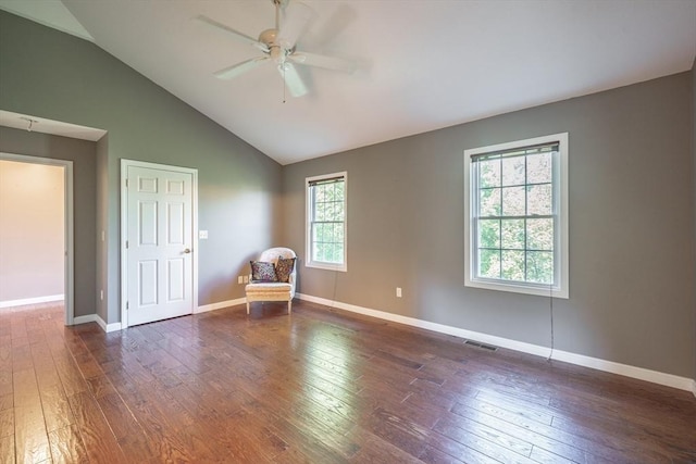 spare room with a ceiling fan, dark wood-style flooring, baseboards, and high vaulted ceiling