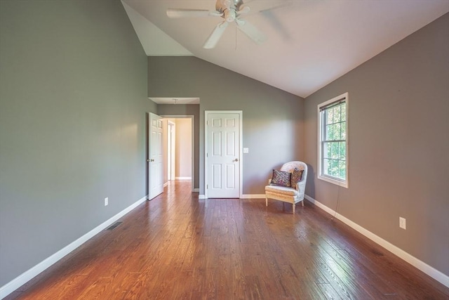 living area with ceiling fan, dark wood-type flooring, baseboards, and high vaulted ceiling