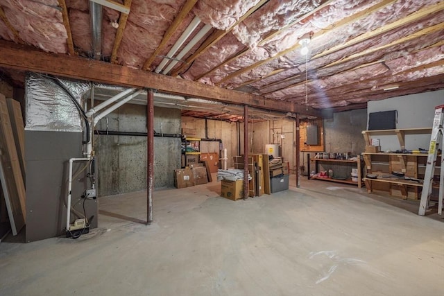 unfinished below grade area with water heater and electric panel