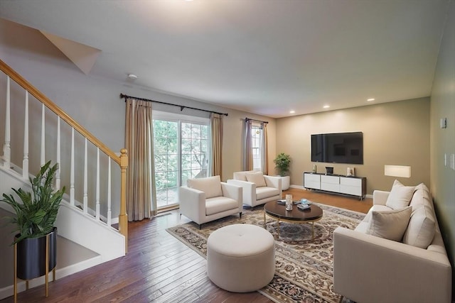 living room with hardwood / wood-style flooring, stairs, recessed lighting, and baseboards