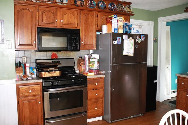 64 Garfield Ave, Woburn, MA 01801 - kitchen with black appliances, brown cabinetry, and light countertops