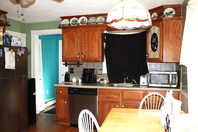 64 Garfield Ave, Woburn, MA 01801 - kitchen featuring appliances with stainless steel finishes, a sink, backsplash, and light countertops