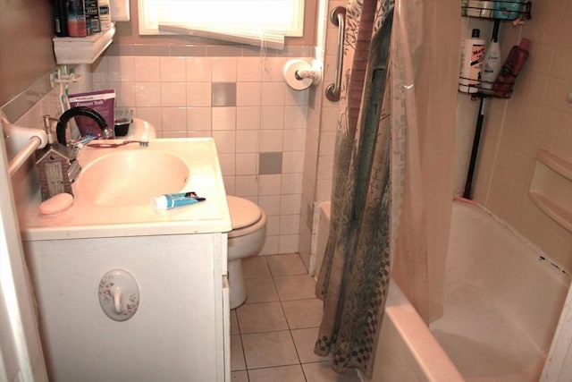 64 Garfield Ave, Woburn, MA 01801 - bathroom with vanity, tile walls, tile patterned flooring, toilet, and shower / bathtub combination with curtain