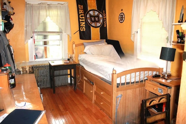64 Garfield Ave, Woburn, MA 01801 - bedroom with radiator heating unit and hardwood / wood-style flooring