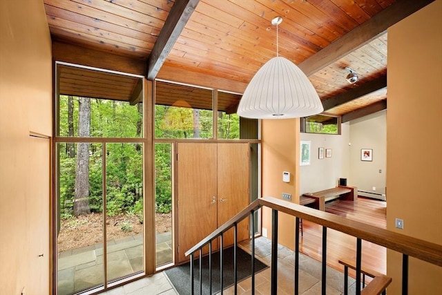 183 Indian Hl, Carlisle, MA 01741 - hallway with wooden ceiling with exposed beams, healthy amount of natural light, a baseboard radiator, and an upstairs landing