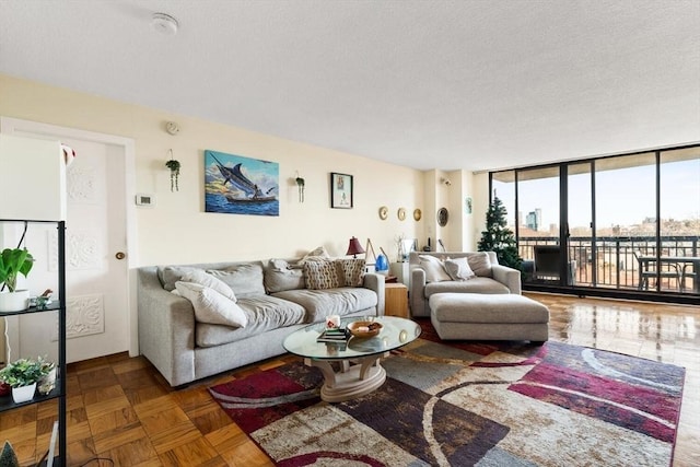 living room featuring dark parquet floors, floor to ceiling windows, and a textured ceiling