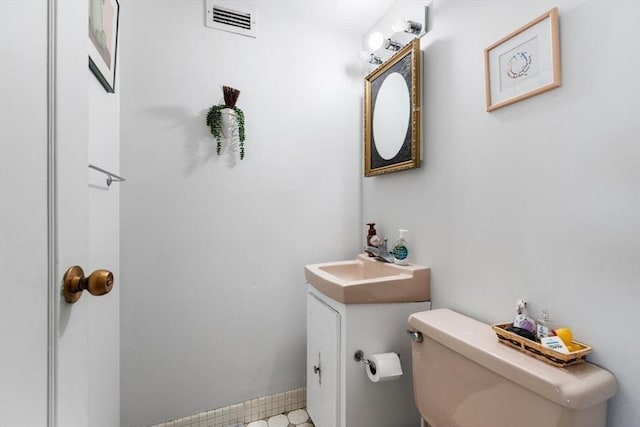 bathroom featuring toilet and vanity