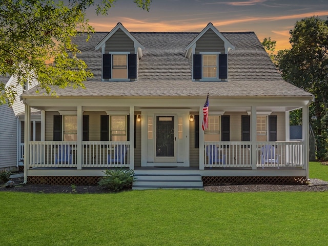 view of front facade featuring a lawn and covered porch