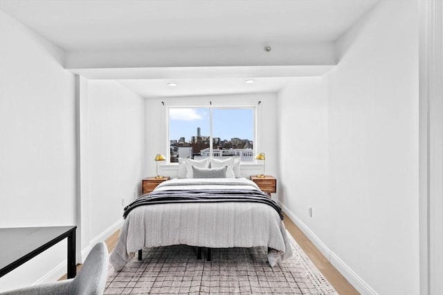 bedroom with baseboards and wood finished floors