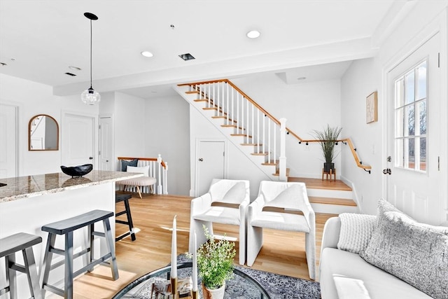 living area with stairway, recessed lighting, and light wood-style flooring