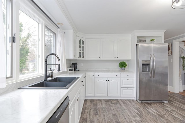 197 N St, Mattapoisett, MA 02739 - kitchen with appliances with stainless steel finishes, a sink, plenty of natural light, white cabinets, and ornamental molding