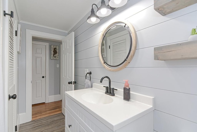 197 N St, Mattapoisett, MA 02739 - bathroom with crown molding, wood finished floors, vanity, wooden walls, and baseboards
