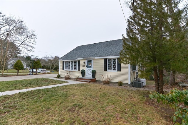 197 N St, Mattapoisett, MA 02739 - new england style home with roof with shingles, a front lawn, and concrete driveway