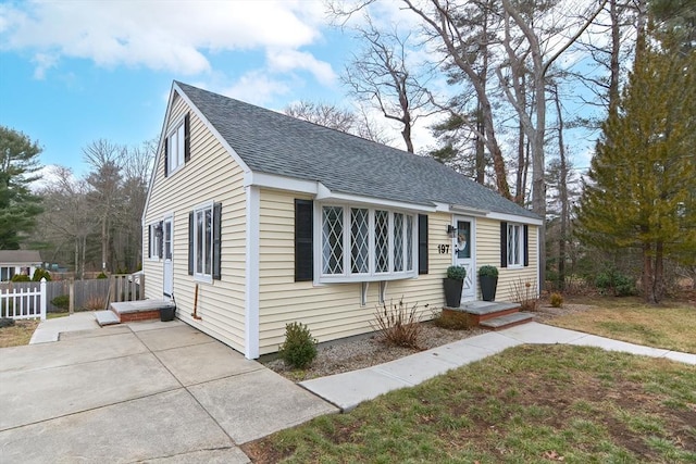 197 N St, Mattapoisett, MA 02739 - view of front of home with fence, roof with shingles, and a patio area