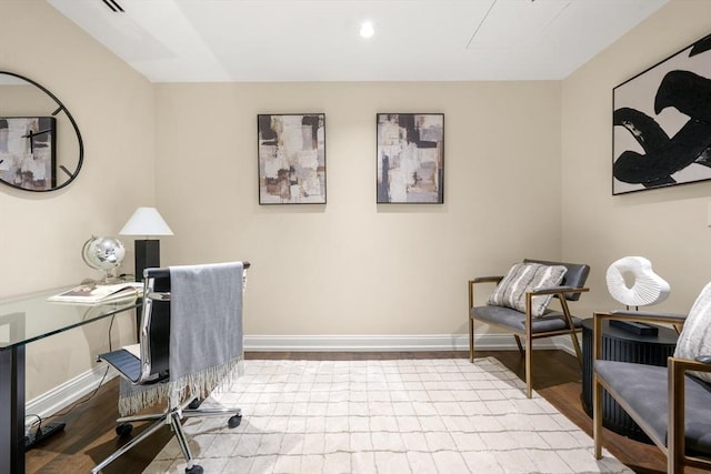 office area with baseboards and wood finished floors