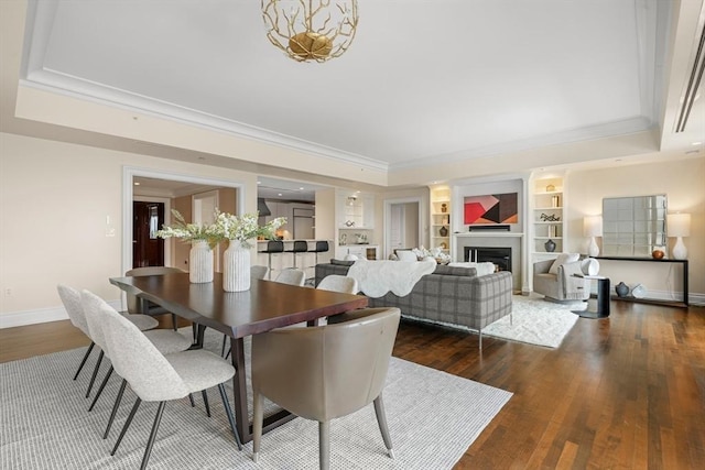 dining room featuring a fireplace, baseboards, crown molding, and dark wood-type flooring