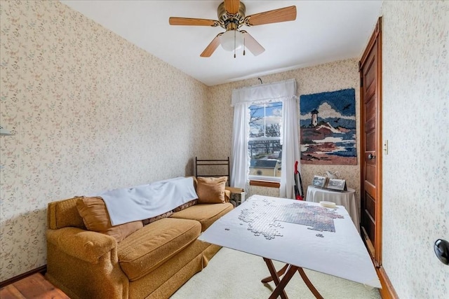 sitting room with ceiling fan and hardwood / wood-style flooring