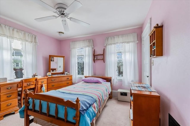 bedroom featuring light carpet and ceiling fan