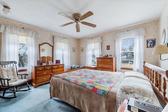 bedroom featuring ceiling fan, light colored carpet, and multiple windows