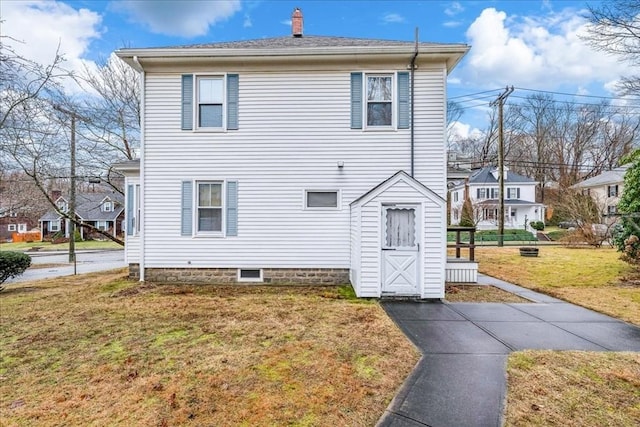 rear view of house with a yard