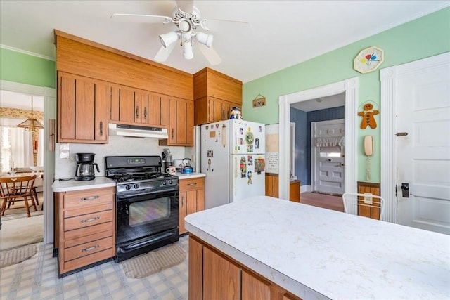 kitchen with gas stove, ceiling fan, and white refrigerator