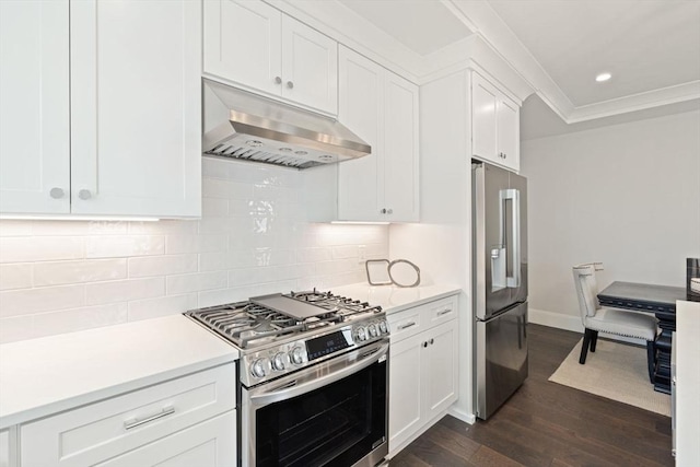 7 Milk St, Natick, MA 01760 - kitchen featuring appliances with stainless steel finishes, under cabinet range hood, dark wood-style floors, light countertops, and ornamental molding