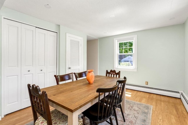 8 May St, Sharon, MA 02067 - dining space with baseboard heating and light wood-style flooring