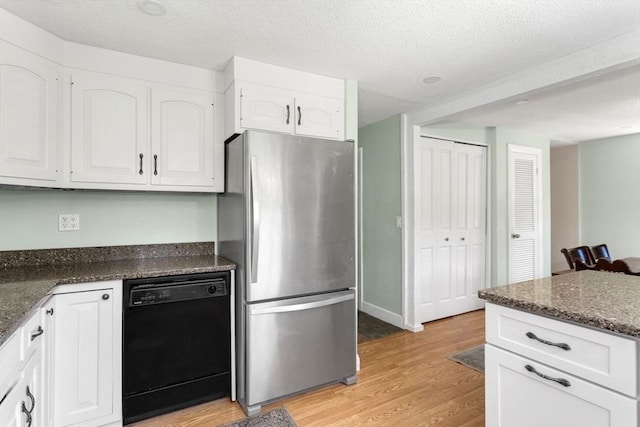 8 May St, Sharon, MA 02067 - kitchen featuring dishwasher, freestanding refrigerator, white cabinets, light wood-style flooring, and a textured ceiling