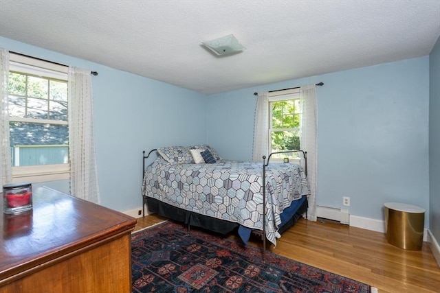 8 May St, Sharon, MA 02067 - bedroom featuring a baseboard radiator and wood finished floors