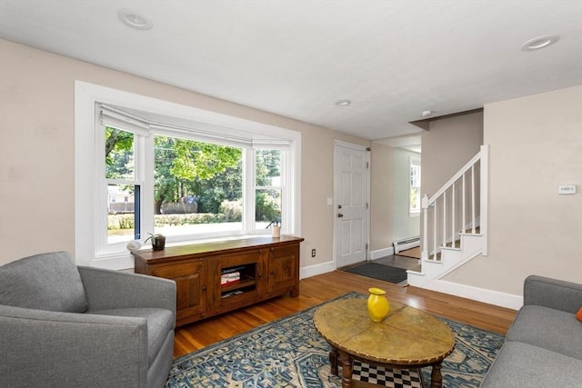 8 May St, Sharon, MA 02067 - living area featuring baseboard heating, wood finished floors, stairway, plenty of natural light, and recessed lighting
