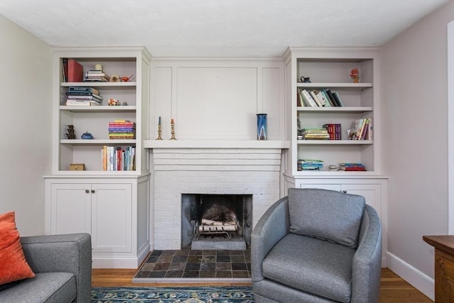 8 May St, Sharon, MA 02067 - living area featuring built in shelves, a fireplace, and wood finished floors