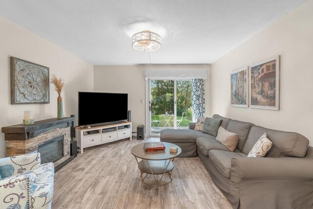 79 Chilton Ln Unit 79, Brewster, MA 02631 - living room featuring light wood-style floors and a fireplace
