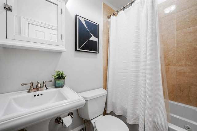 full bathroom with sink, shower / bathtub combination with curtain, and toilet