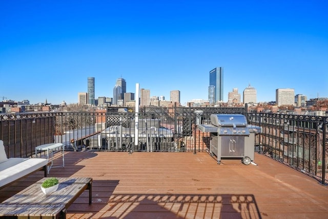 wooden deck featuring a grill